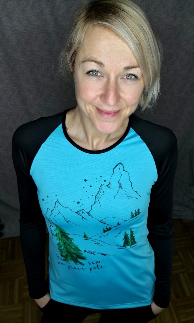 A loose-fitting black T-shirt with long, fitted sleeves, featuring an illustration of a Rainbow Poppy.