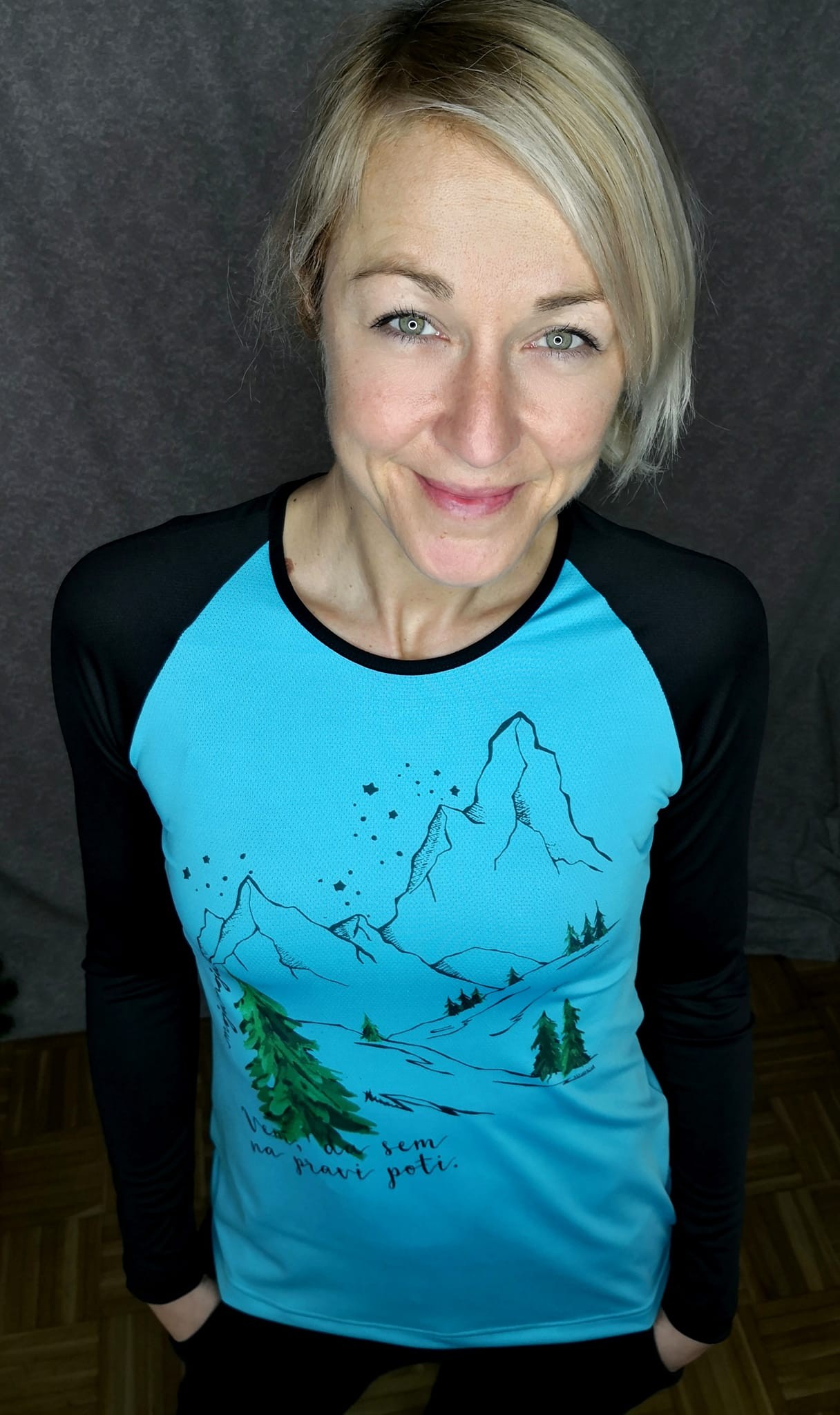 A loose-fitting black T-shirt with long, fitted sleeves, featuring an illustration of a Rainbow Poppy.