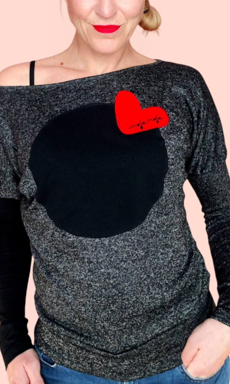 Black short skirt with a red heart, made of cotton sweatshirt fabric.